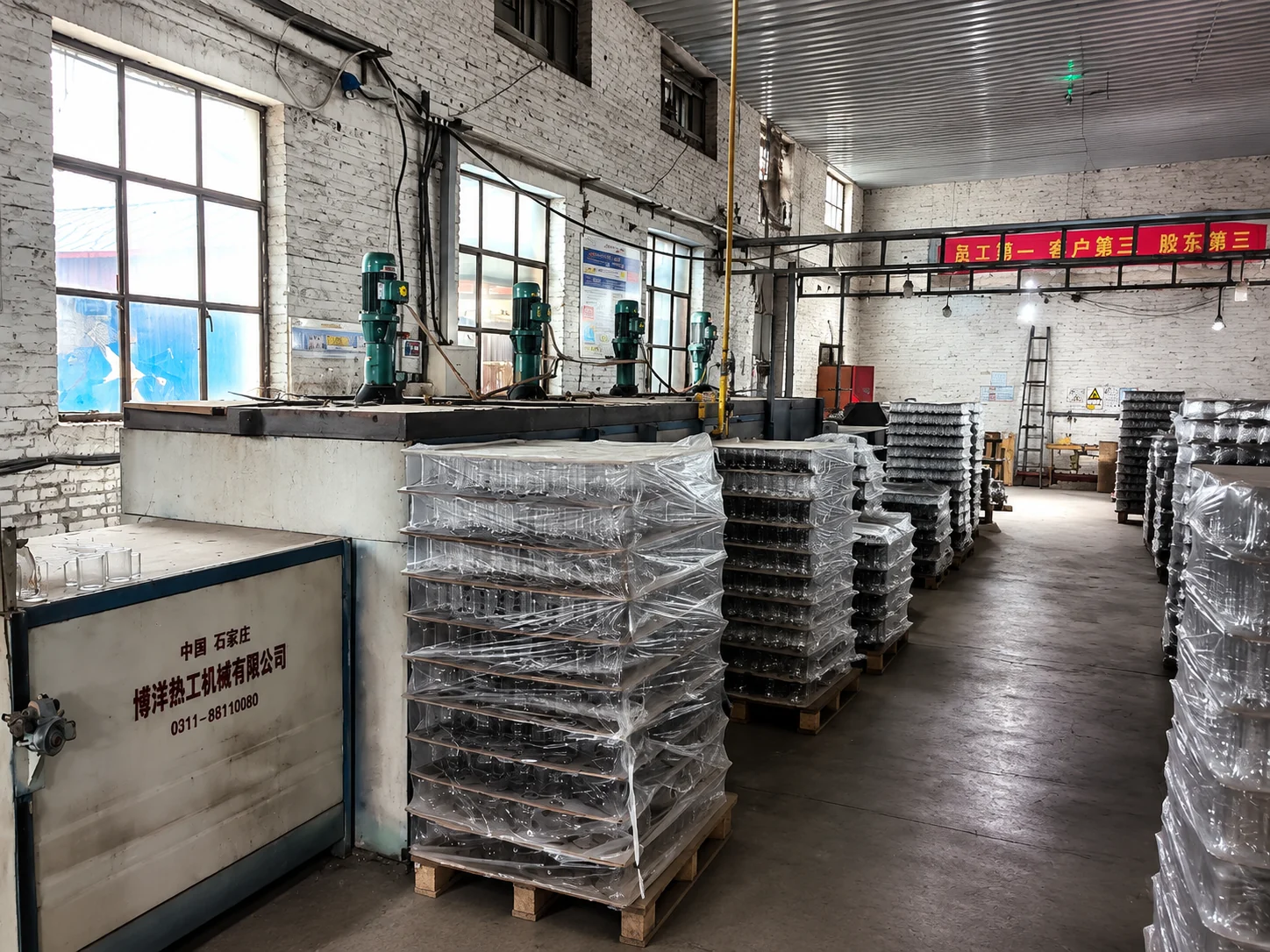 Production equipment and protected glassware trays inside a partner workshop